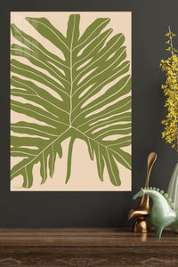 Olive Tropical Leaf Silhouette metal wall art displayed in a modern interior