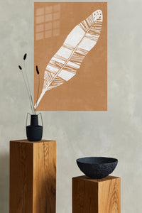 White Feather on Terracotta metal wall art displayed in a modern interior