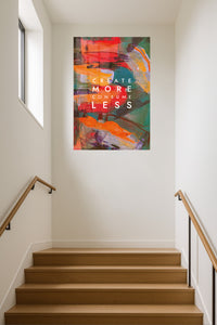 Create More Consume Less metal wall art displayed in a contemporary living space