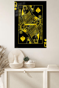 Golden Queen of Spades metal wall art displayed in a modern interior